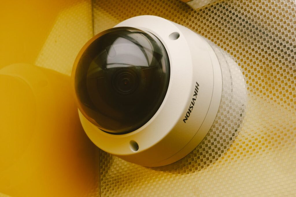 Close-up of a modern security camera installed indoors, ideal for surveillance.